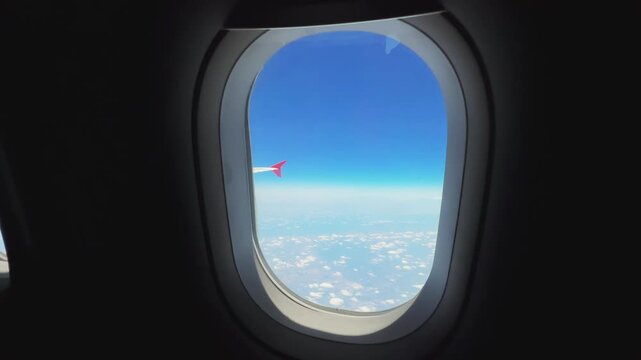 Motion forward look through Airplane Window during the high flight over the clouds