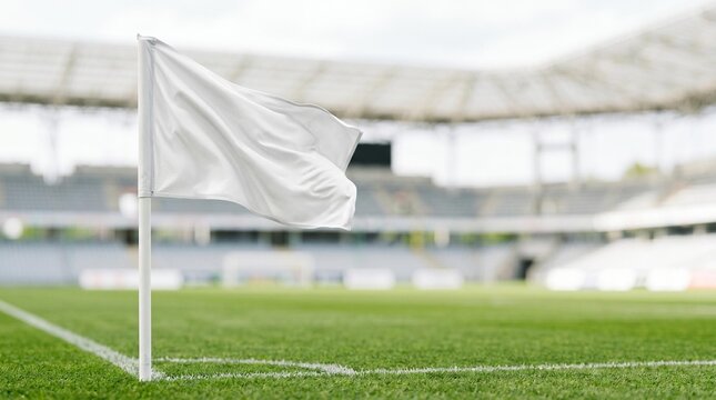 White corner flag waving on empty soccer stadium field