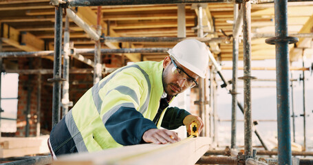 Fototapeta premium Planning, man and construction worker by infrastructure on site for building, repairs or maintenance. Wood, professional and male civil engineer with timber measurement for home renovation project.