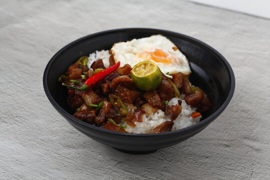 Filipino food called Sisig served as toppings on a rice bowl