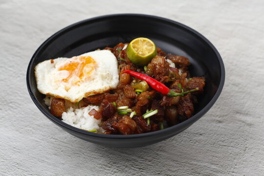 Filipino food called Sisig served as toppings on a rice bowl