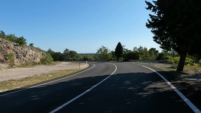 riding down an empty road in italy lined with cypress trees (tall pointed coastal cypresses) Mediterranean coast europe european travel bike biking highway tourism eu trieste