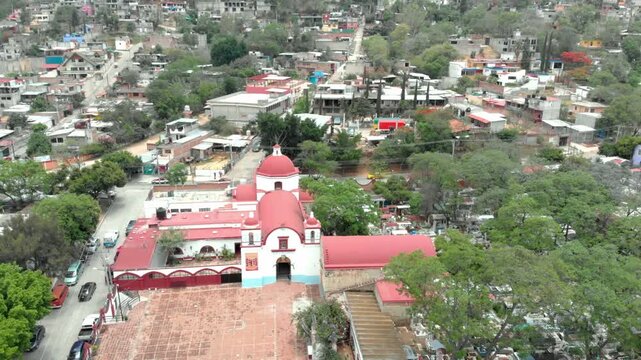 Aerial view of historic church surrounded by residential neighborhood, trees and urban landscape with cultural architecture and community atmosphere