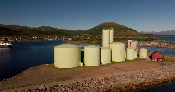 Large industrial silos and fish processing plant on coast of Melbu in Lofoten Islands, Norway. Aerial drone