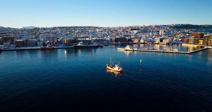Iconic Hermes II boat approach Tromso harbor after sightseeing trip. Aerial
