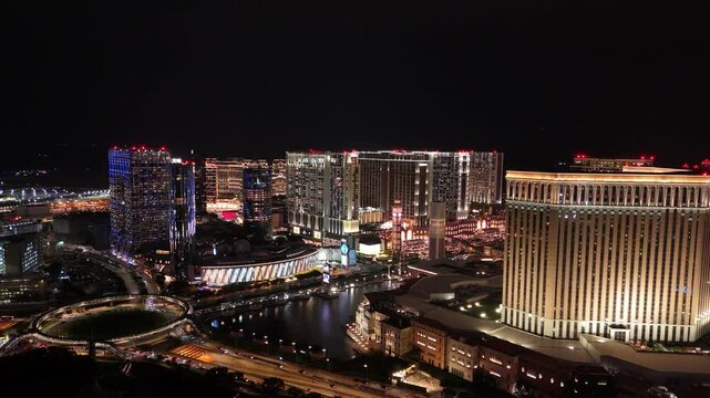 Drone rising, view of Venetian Macao Casino, Morpheus and other buildings in Macau