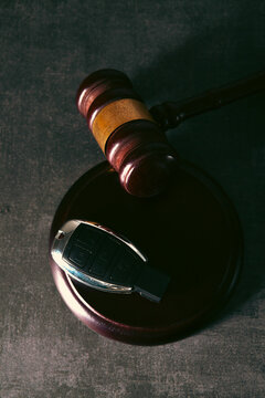 Law theme, mallet of judge, wooden gavel on black background