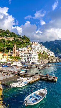A picturesque coastal town on a hillside with boats in the sea