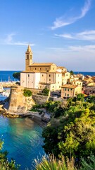 Naklejka premium A picturesque coastal town with a church and buildings on a cliffside, overlooking a serene body of water