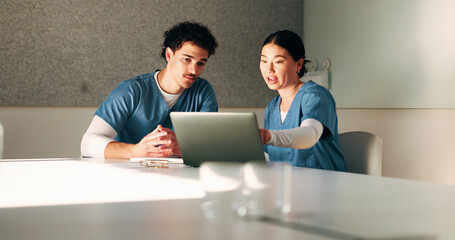 Nurse, discussion and team with laptop in clinic, administration and reading medical records on web. Healthcare specialist, online and people with tech for test results, info and research in hospital