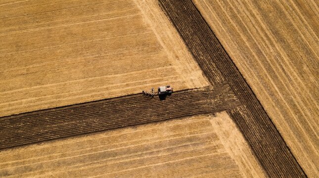 Aerial View of Tractor Creating Geometric Plowing Pattern in Field