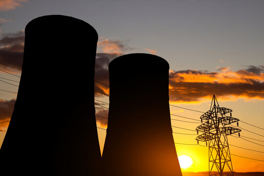 Silhouette of a cooling towers of nuclear power station against the sunset