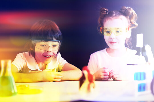 Background with highlights of children of scientists. A boy and a girl are experimenting in the laboratory.