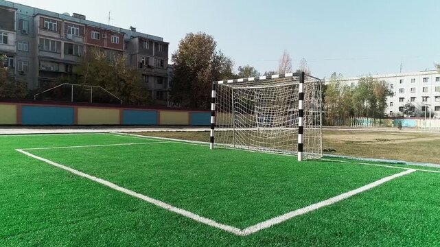 Tashkent, Uzbekistan - 06 06 2025: School soccer field with goal on artificial turf