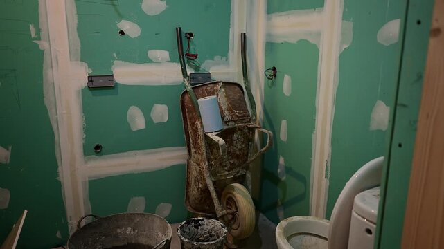 Construction tools standing inside a bathroom under construction