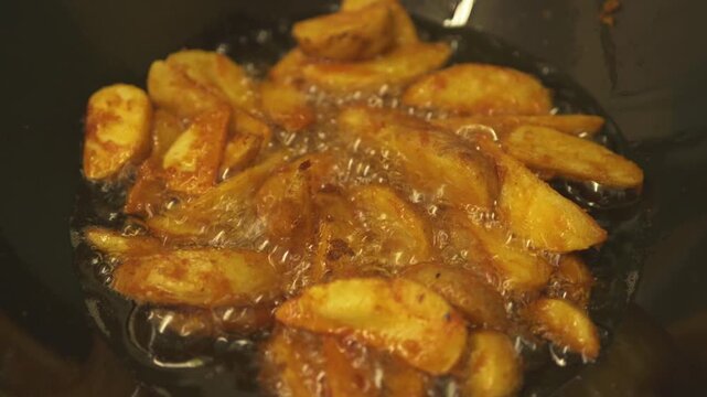 Golden Fried Plantains Sizzling in Wok With Hot Oil and Crispy Edges Cooking on Stove in England UK