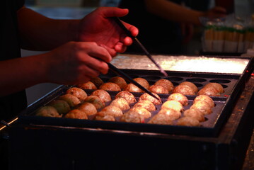 Cooking Tagoyaki, Japanese style octopus balls © Vassire