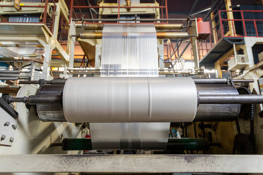 Plastic film unwinding into large industrial roll