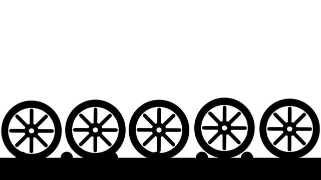 Five automotive wheels arranged in a horizontal row on a shared platform, representing a tire rack display or wheel storage setup in a garage or service shop
