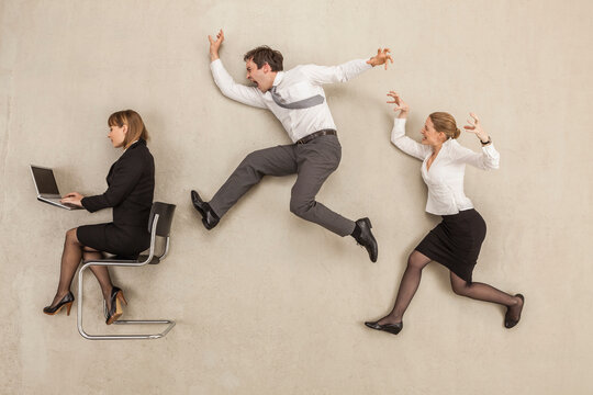 Business people chasing in office