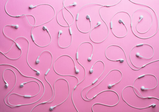 White earphones on pink background, 3D Rendering