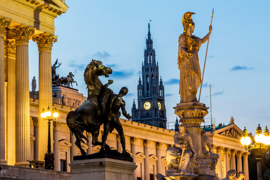 Austria, Vienna, view to parliament building, town hall tower and statue of goddess Pallas Athene by twilight
