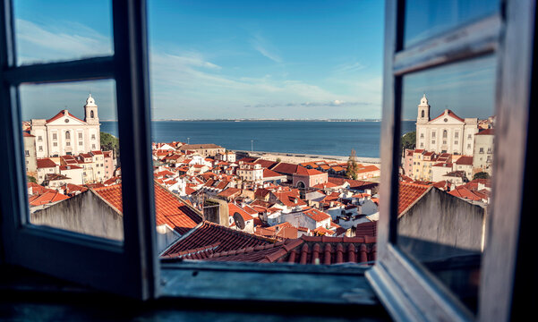 Portugal, Lisbon, view of Alfama neighborhood and River Tejo through open window