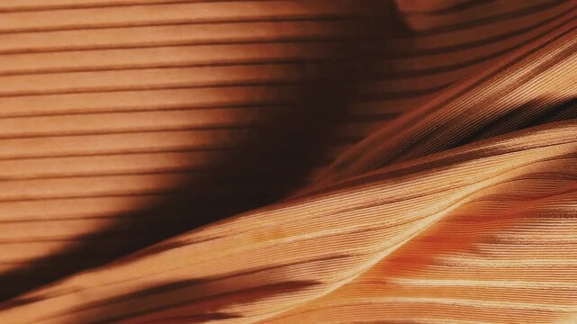 Abstract brown fabric wave background with flowing textile folds and elegant material texture for luxury design concepts.