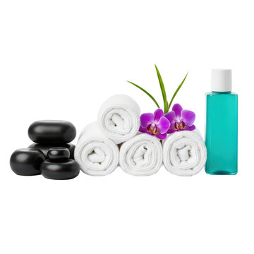 Spa essentials with hot stones rolled towels orchid and turquoise lotion bottle