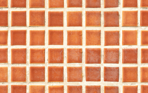Seamless terracotta tile texture background with orange mosaic square blocks and rustic ceramic grid for interior mockup design