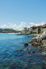 Obraz premium Village by water with cheerful surroundings. Sundrenched coastal hamlet with shimmering surfaces and peaceful breezes creating perfect vacation ambiance for travelers