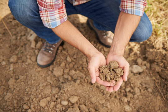 Farmer holding soil in his hands