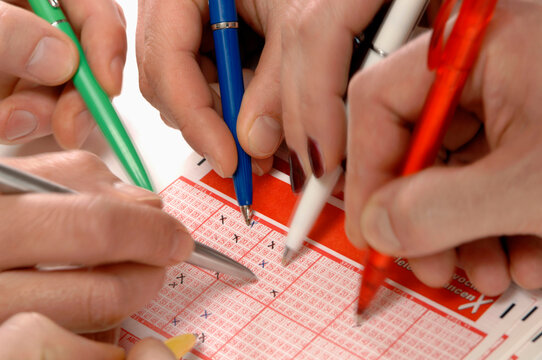 Filling out a lottery coupon, marking with a cross