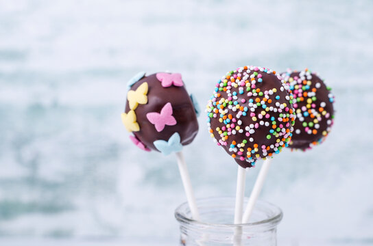 Chocolate cake pops garnished with nonpareils
