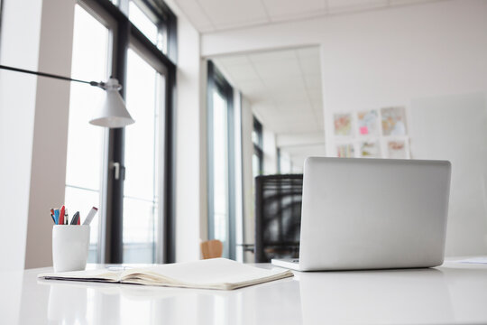 Laptop and notebook on office desk