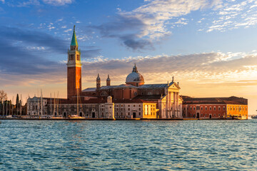 Fototapeta premium beautiful view at Abbey of San Giorgio Maggiore from San Marco square in Venice, Italy. Venetian sunset landscape of antique architecture.