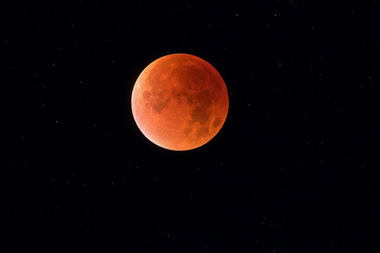 Total lunar eclipse with stars in background, blood moon