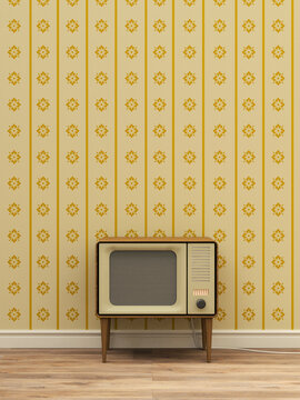 Old television in front of yellow patterned wallpaper