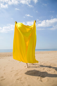 Young woman hidden by bath towel