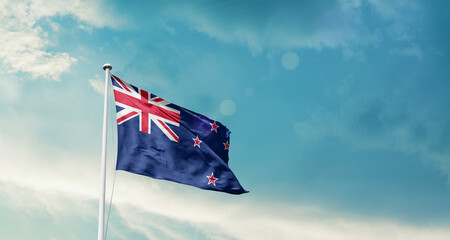 New Zealand national flag fluttering. The flag blowing in beautiful soft sky. New Zealand national flag for independence day.