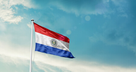 Obraz premium Paraguay national flag fluttering. The flag blowing in beautiful soft sky. Paraguay national flag for independence day.