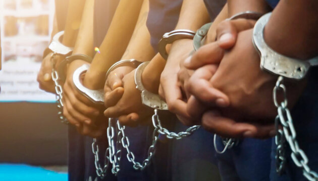 several prisoners' hands were handcuffed with iron handcuffs.