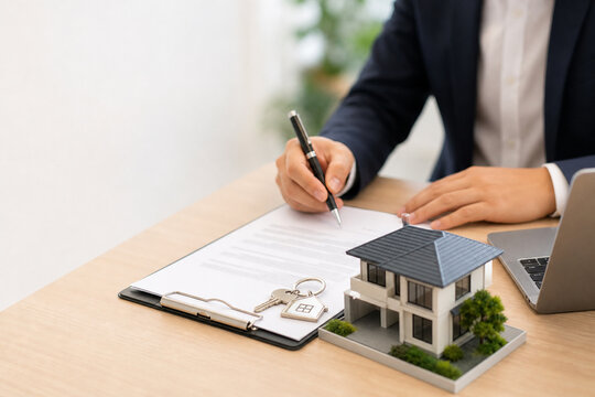 Real estate agreement signing with house model and keys, property purchase, home ownership, mortgage approval, real estate investment, legal contract, residential transaction housing market copy space