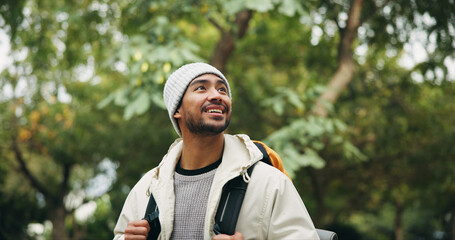 Naklejka premium Happy, thinking and hiking with man in nature for eco tourism, adventure and national park. Sustainability vacation, backpacking and trekking with person outdoor for wellness, idea and vision