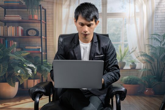 Focused Professional Working on Laptop in Cozy Modern Office