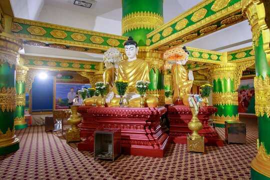 Golden buddha statues serene temple interior religious art tranquil environment captivating viewpoint cultural exploration