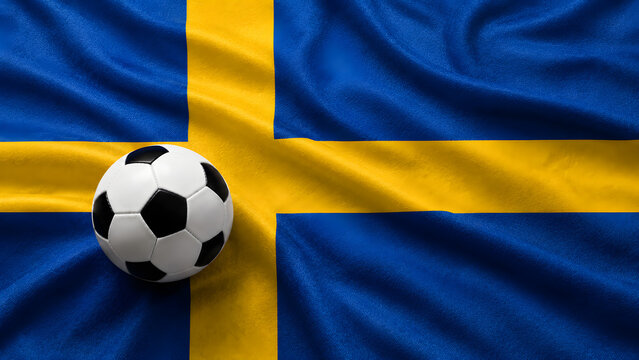A classic black and white soccer ball resting on the textured blue and yellow fabric of the Swedish national flag, symbolizing Swedish football culture.