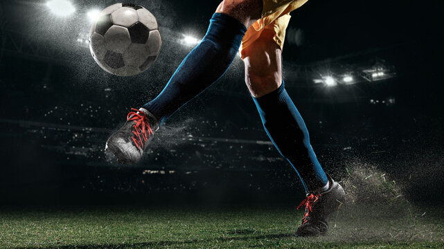 Powerful soccer kick with flying turf under night stadium lights. Concept of footwear promotion, sports retailer banners, performance marketing, championship posters, and soccer gear campaigns.