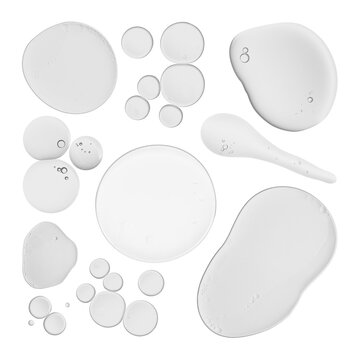 Clear liquid drops and smears of various shapes and sizes, possibly cosmetic serum or gel, on a white background.