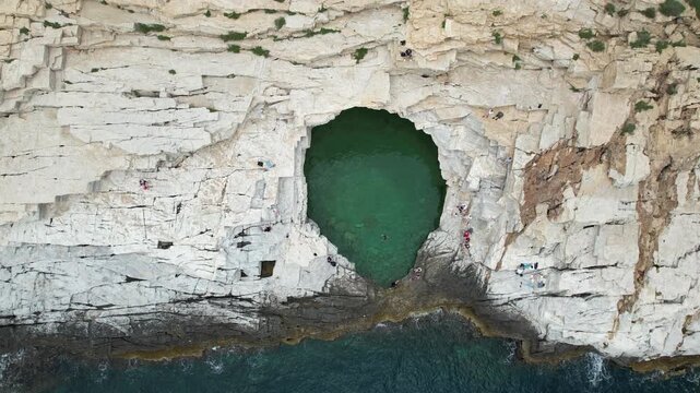 People swimming in giola natural pool in thassos greece